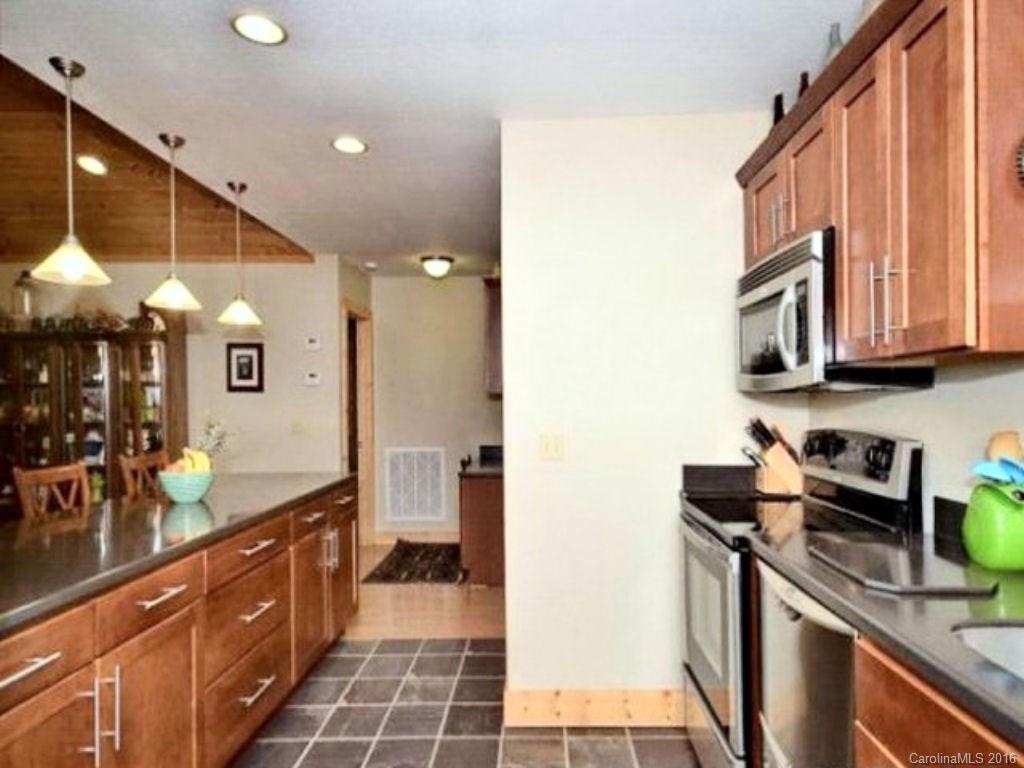 2574 Cabin Flats Road Sylva, NC 28779 - Photo 13 of 22 a kitchen with stainless steel appliances granite countertop a sink and a stove top oven