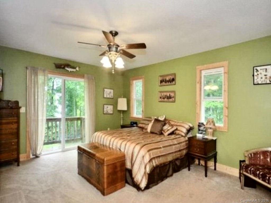 2574 Cabin Flats Road Sylva, NC 28779 - Photo 14 of 22 a spacious bedroom with a bed and a window