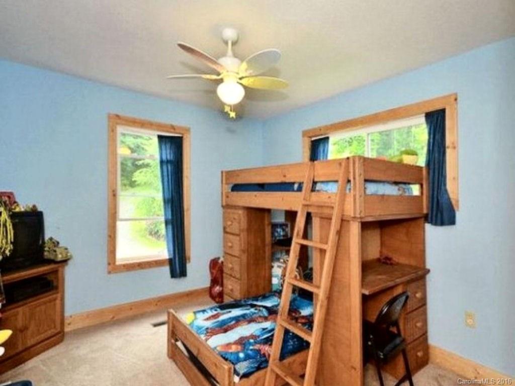 2574 Cabin Flats Road Sylva, NC 28779 - Photo 15 of 22 a bed room with a bed and a tv