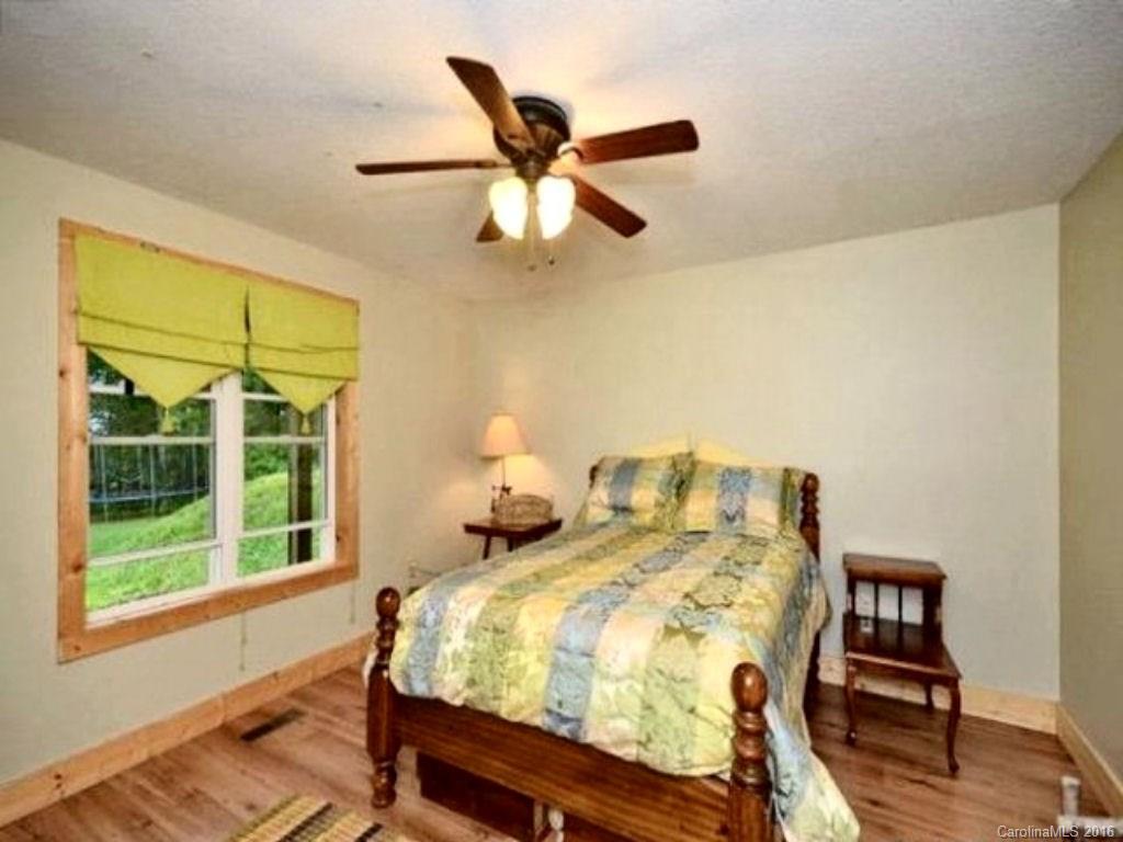 2574 Cabin Flats Road Sylva, NC 28779 - Photo 16 of 22 a bed room with a bed and a window
