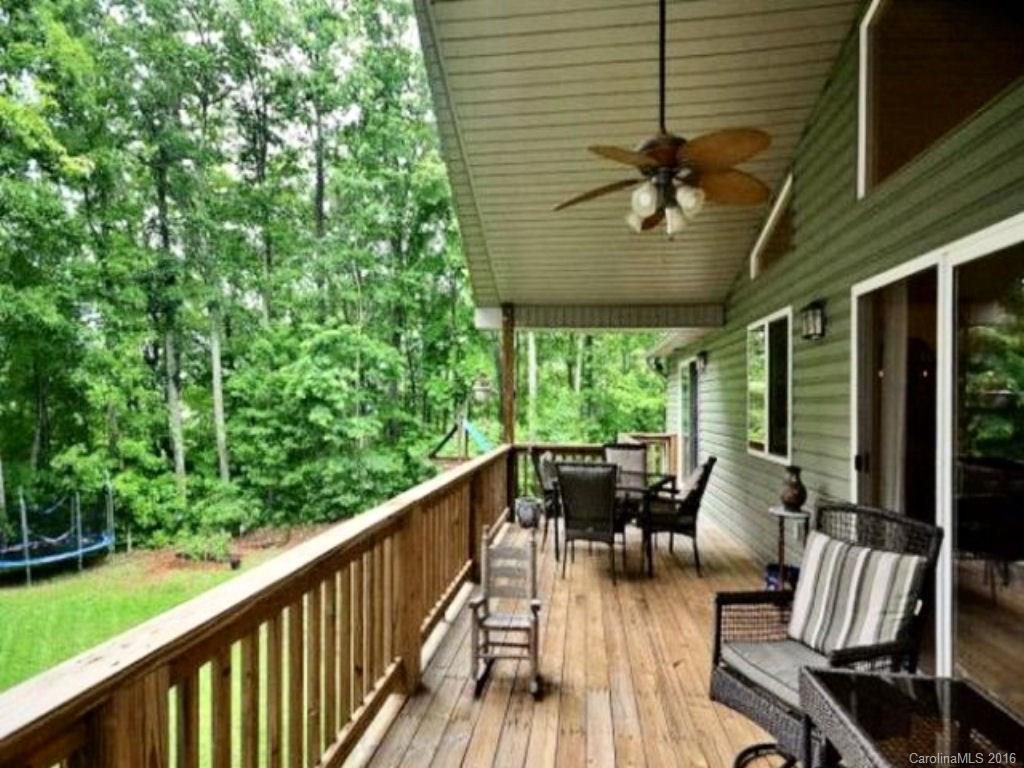 2574 Cabin Flats Road Sylva, NC 28779 - Photo 7 of 22 a roof deck with table and chairs and wooden floor