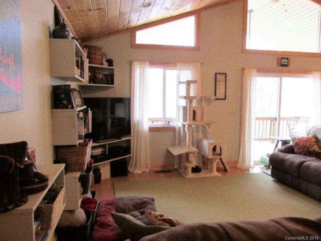 2574 Cabin Flats Road Sylva, NC 28779 - Photo 9 of 22 a living room with furniture a window and gym equipment