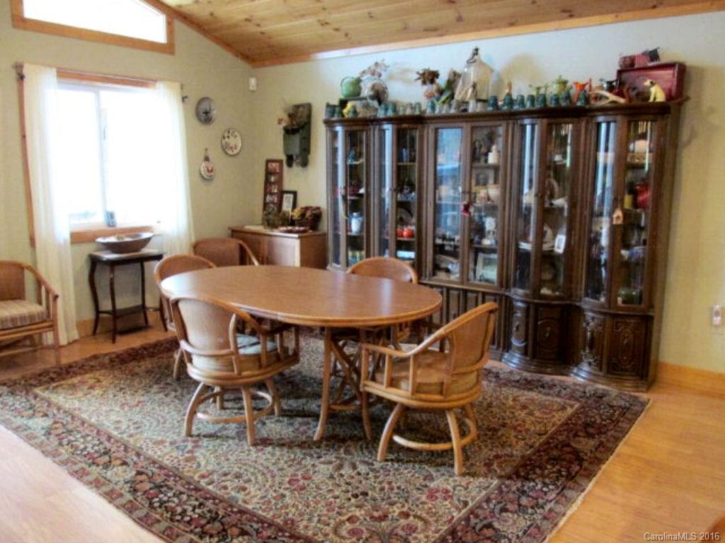 2574 Cabin Flats Road Sylva, NC 28779 - Photo 10 of 22 a dining room with furniture and wooden floor
