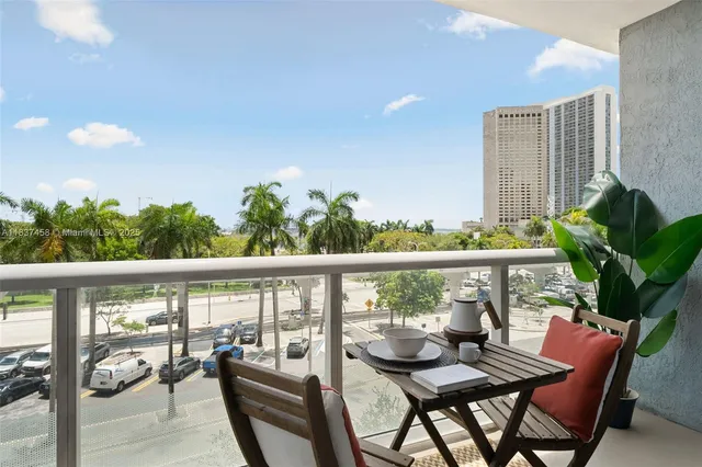 a view of a balcony with chairs and wooden floor