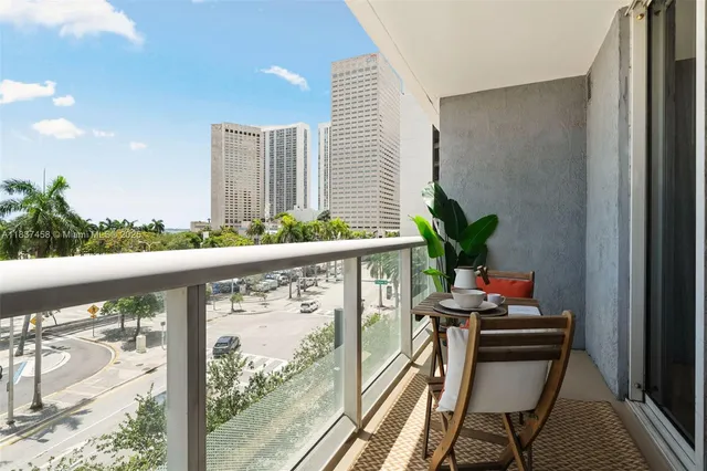 a dining room with furniture and a potted plant