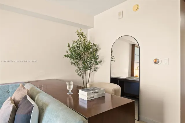 a living room with furniture and a potted plant