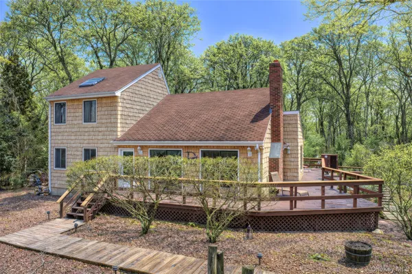 a view of a house with backyard porch and sitting area