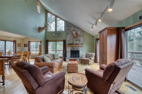 a living room with furniture fireplace and a large window