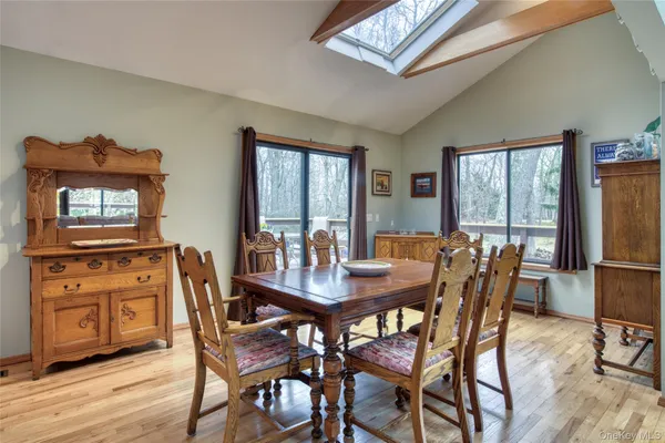 a view of a dining room with furniture window and wooden floor