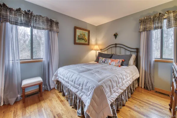 a bedroom with a bed table and a window
