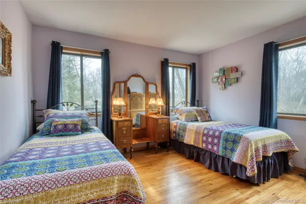 a bedroom with two beds and a large window
