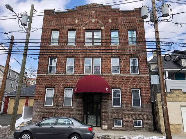 a front view of a building with many windows