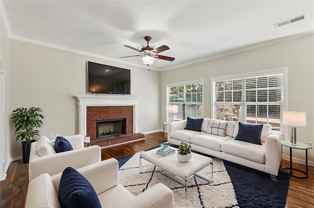 2435 Cobble Creek Lane Grayson, GA 30017 - Photo 13 of 39 a living room with furniture a flat screen tv and a fireplace