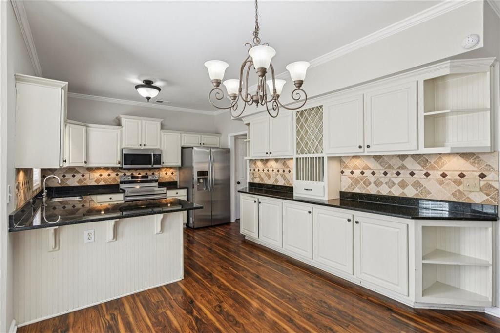 2435 Cobble Creek Lane Grayson, GA 30017 - Photo 20 of 39 a kitchen with stainless steel appliances granite countertop a sink and cabinets