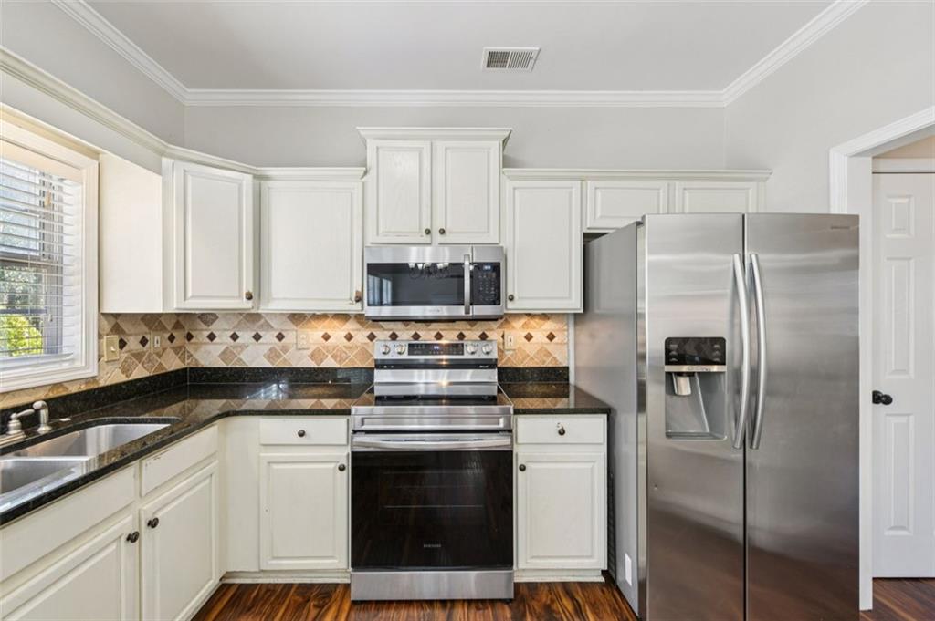 2435 Cobble Creek Lane Grayson, GA 30017 - Photo 25 of 39 a kitchen with stainless steel appliances a refrigerator stove and sink