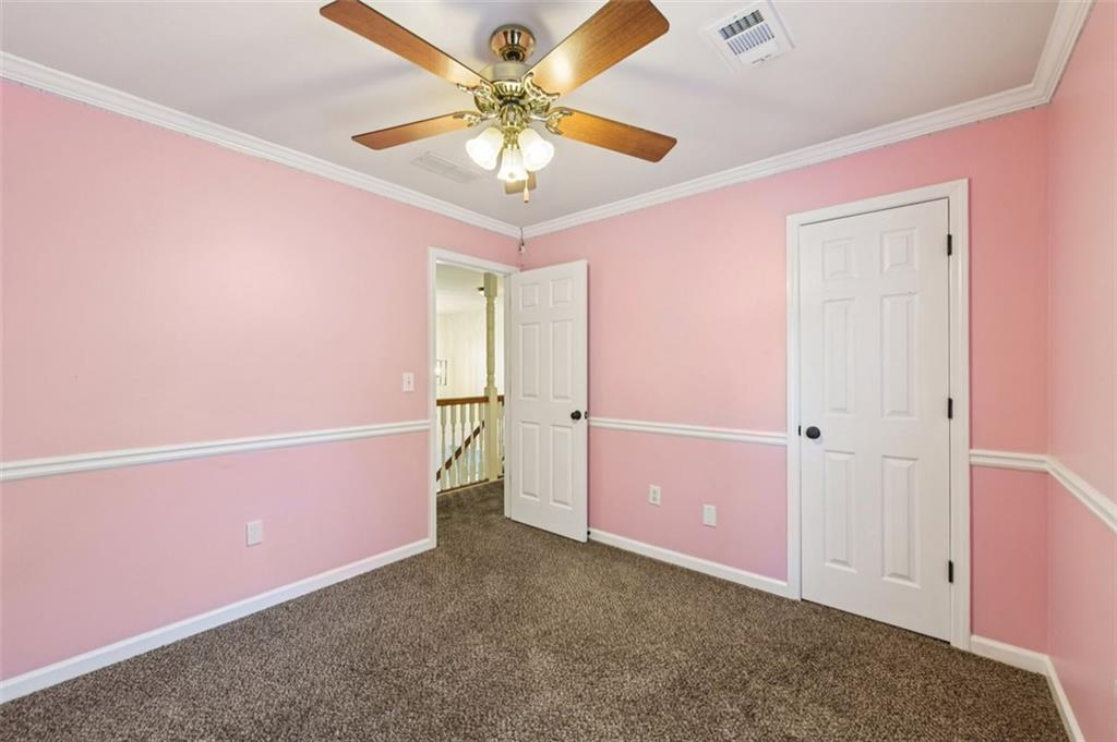 2435 Cobble Creek Lane Grayson, GA 30017 - Photo 28 of 39 an empty room with a ceiling fan and a window