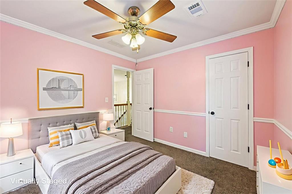 2435 Cobble Creek Lane Grayson, GA 30017 - Photo 29 of 39 a bedroom with a bed and a chandelier