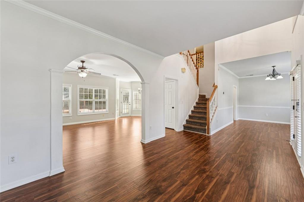 2435 Cobble Creek Lane Grayson, GA 30017 - Photo 9 of 39 a view of a room with wooden floors and stairs