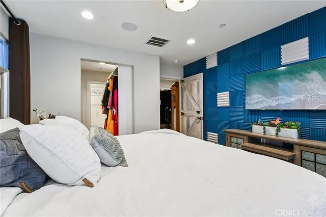 a bedroom with a bed and a flat screen tv