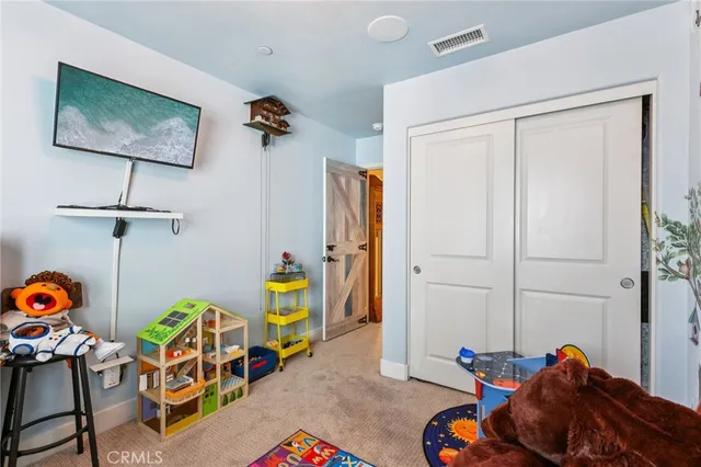 a bedroom with a bed a chandelier and a window