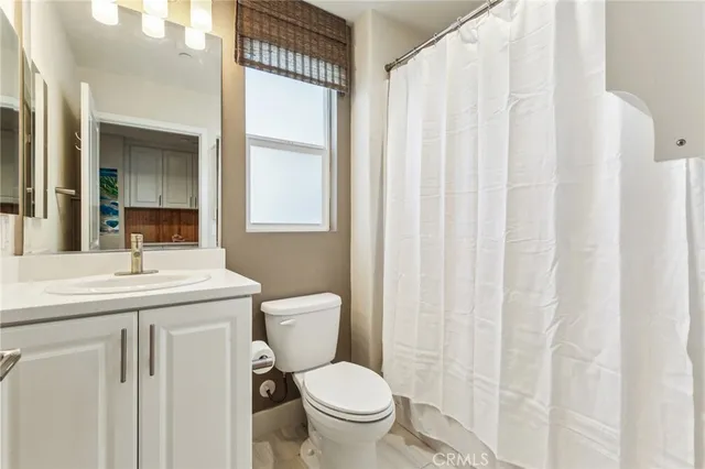 a bathroom with a toilet a sink and a window