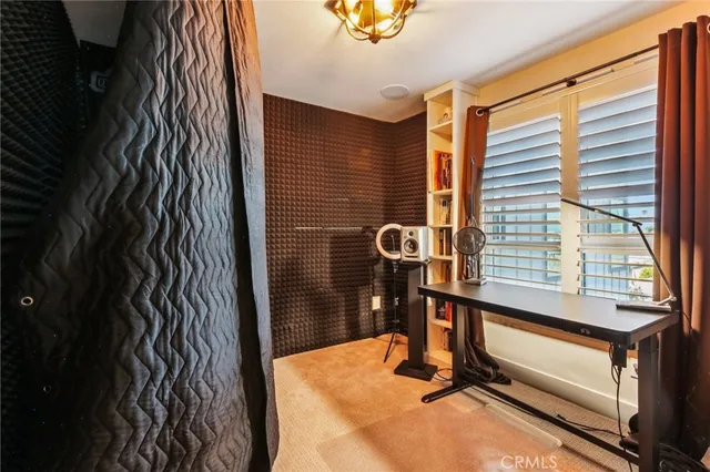 a view of a hallway with wooden floor and a potted plant