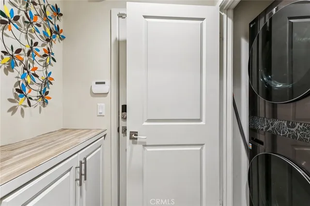 a view of a hallway with wooden floor and entryway