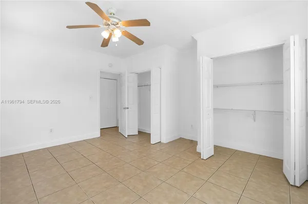 a view of an empty room with a ceiling fan