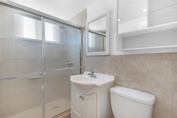 a bathroom with a toilet sink and shower