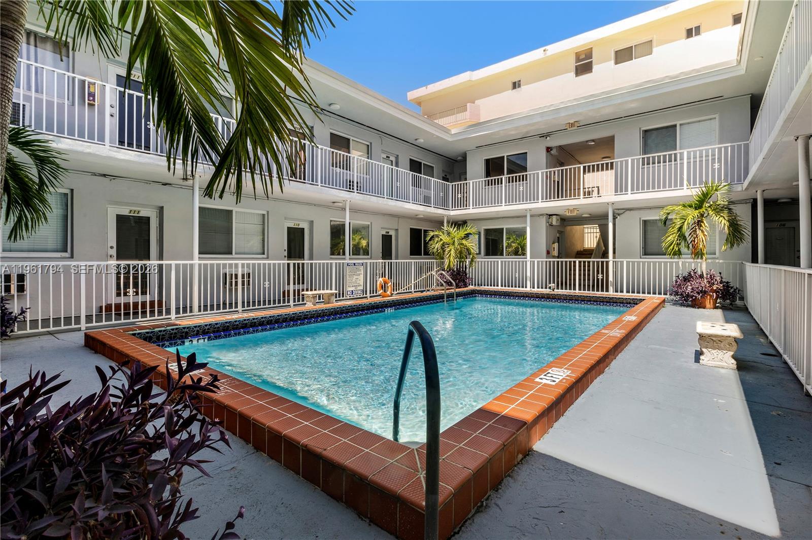 315 69th Street, Unit 112 Miami Beach, FL 33141 - Photo 18 of 20 a view of a patio with a table and chairs
