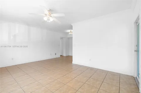an empty room with fan and fan