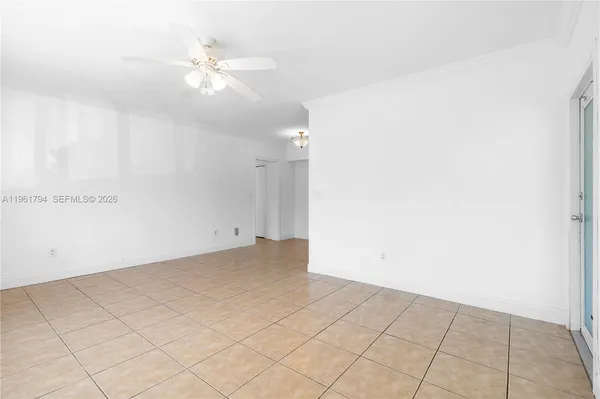 an empty room with fan and fan