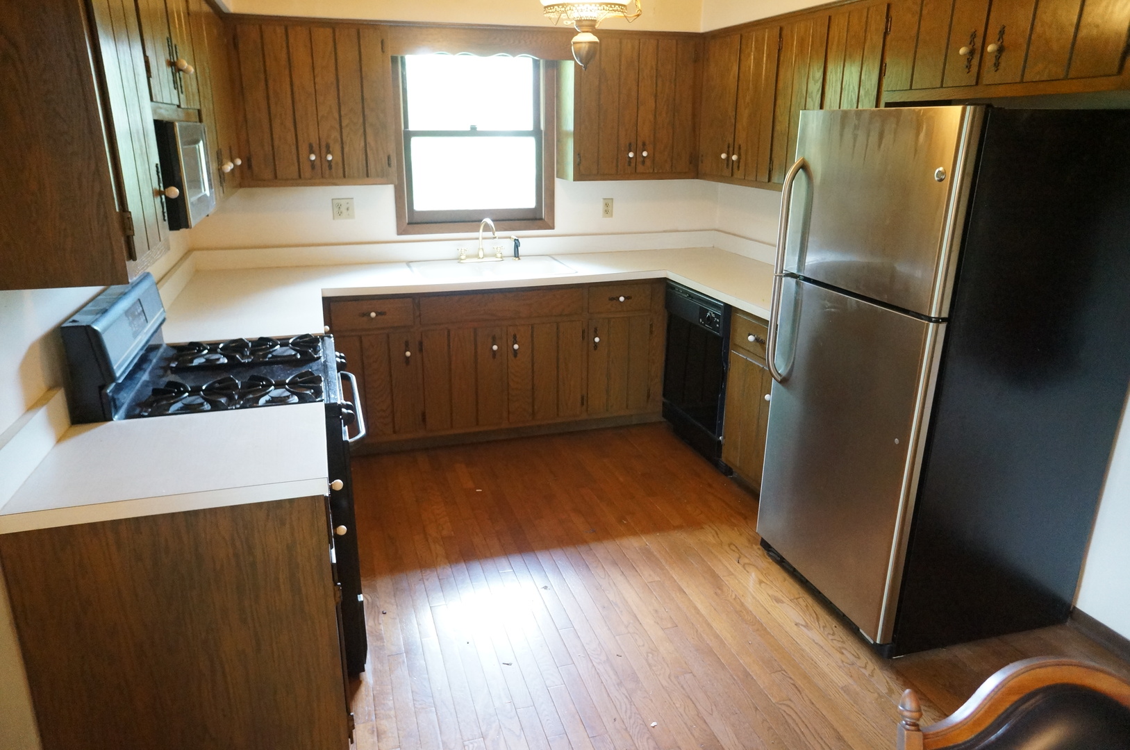 608 Northgate Road New Lenox, IL 60451 - Photo 3 of 16 a kitchen with stainless steel appliances a refrigerator sink and wooden floor