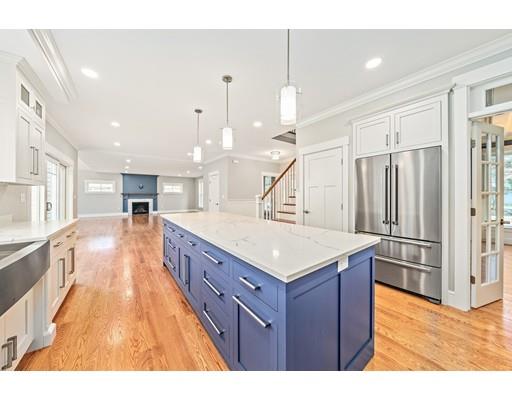 84 Forest Avenue Cohasset, MA 02025 - Photo 2 of 30 a large kitchen with kitchen island a large counter space a sink appliances and cabinets