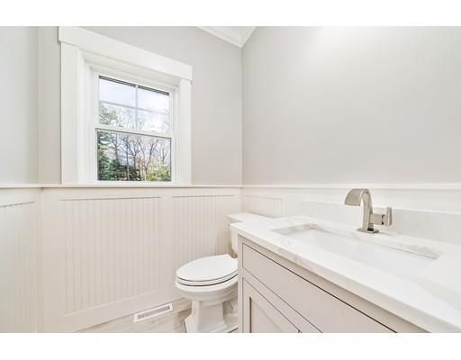 a bathroom with a sink a toilet and a window