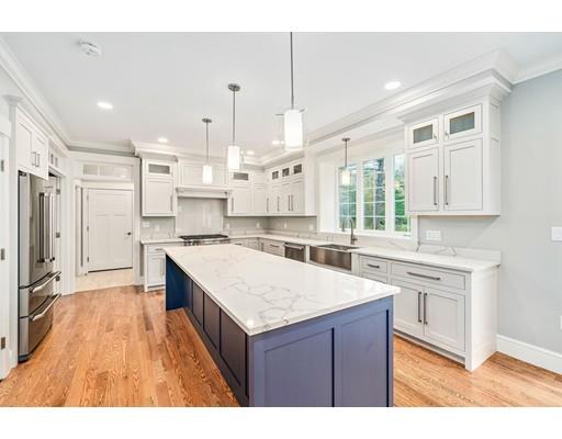 84 Forest Avenue Cohasset, MA 02025 - Photo 4 of 30 a kitchen with a stove a sink a refrigerator and white cabinets with wooden floor