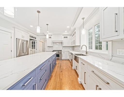 84 Forest Avenue Cohasset, MA 02025 - Photo 7 of 30 a large kitchen with kitchen island a large counter space a sink appliances and cabinets