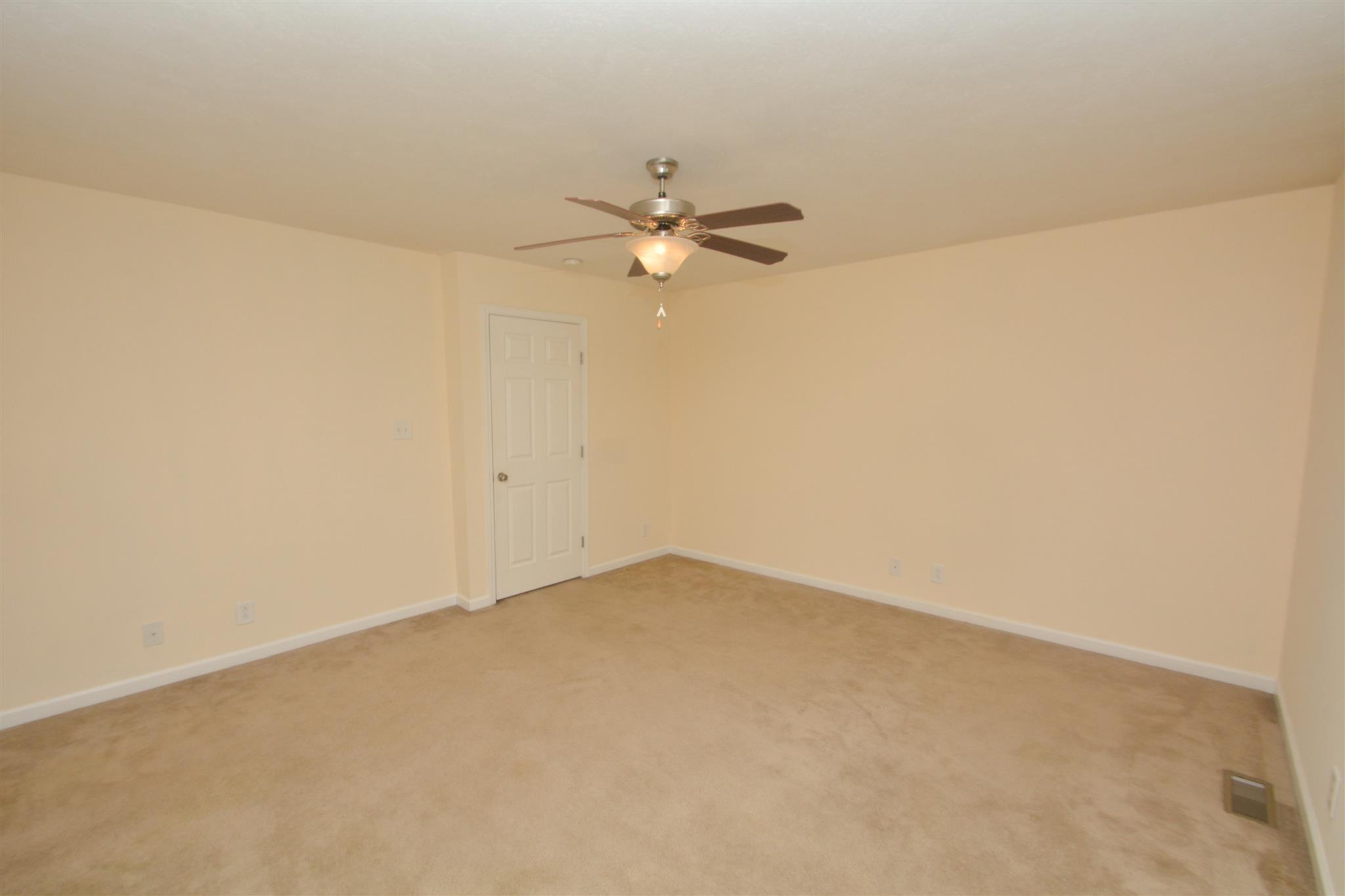 10495 Bell Station Road Oak Grove, KY 42262 - Photo 12 of 18 an empty room with a window and a ceiling fan