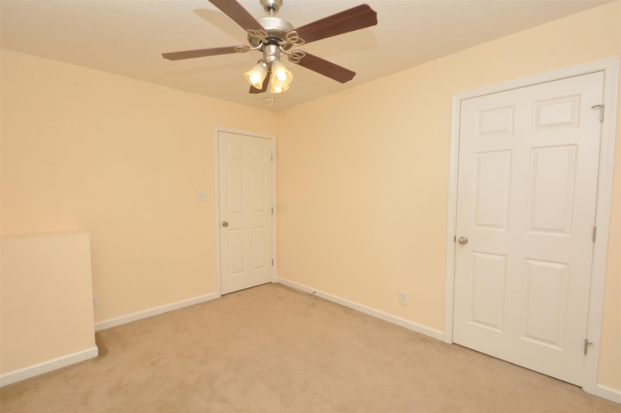 10495 Bell Station Road Oak Grove, KY 42262 - Photo 14 of 18 an empty room with a ceiling fan and a window