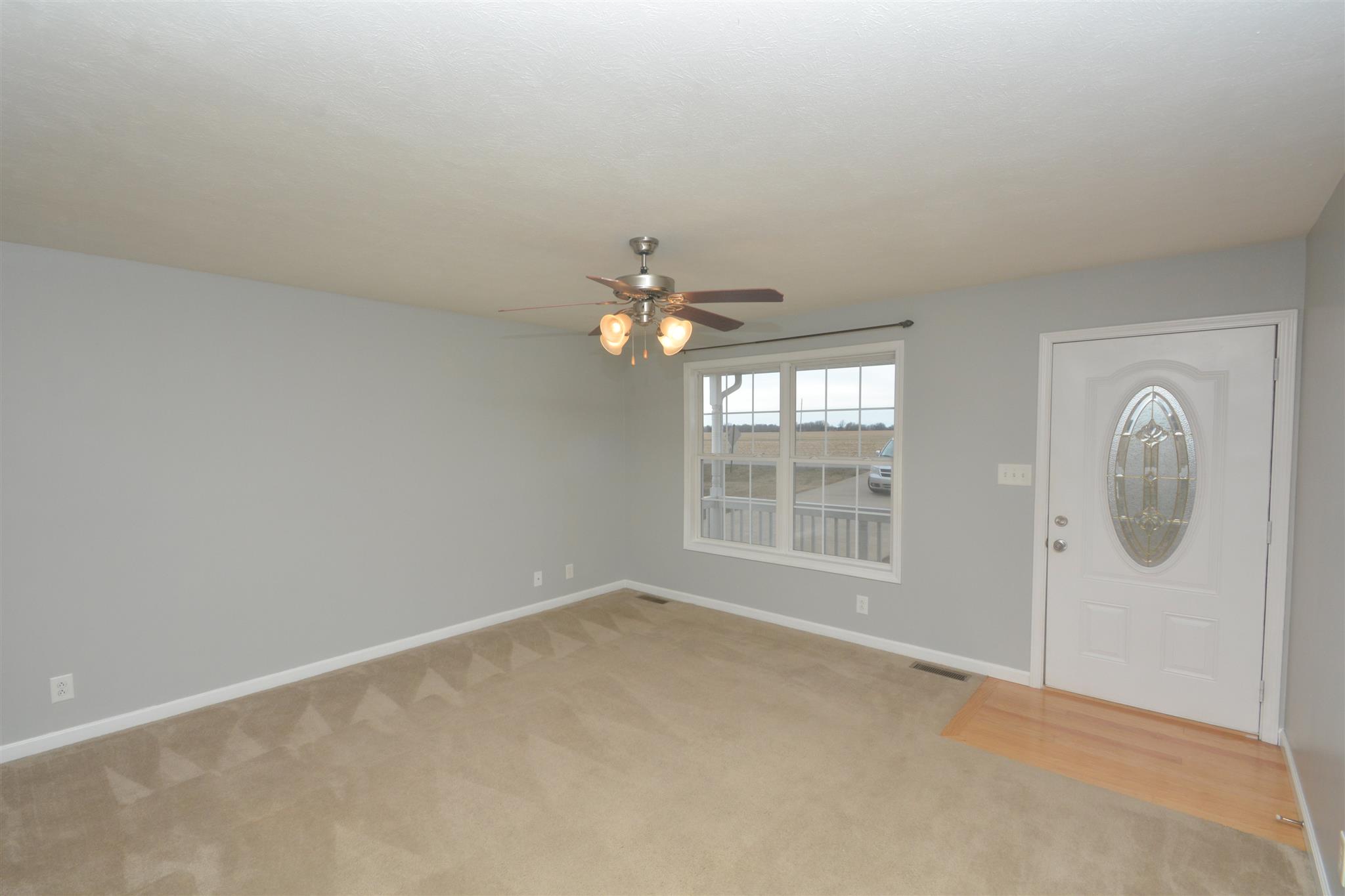 10495 Bell Station Road Oak Grove, KY 42262 - Photo 5 of 18 an empty room with chandelier fan and windows