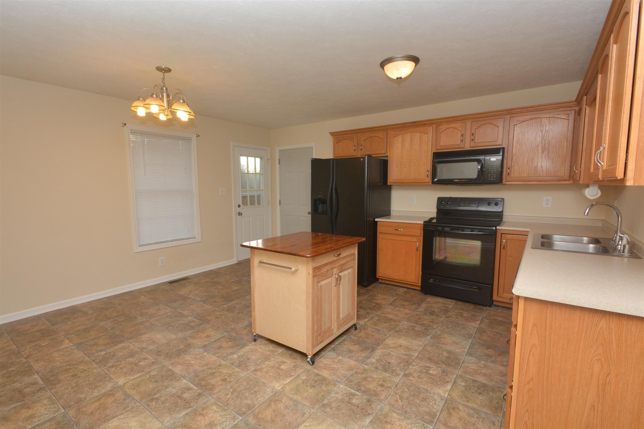 10495 Bell Station Road Oak Grove, KY 42262 - Photo 7 of 18 a kitchen with stainless steel appliances granite countertop a stove a sink and a refrigerator