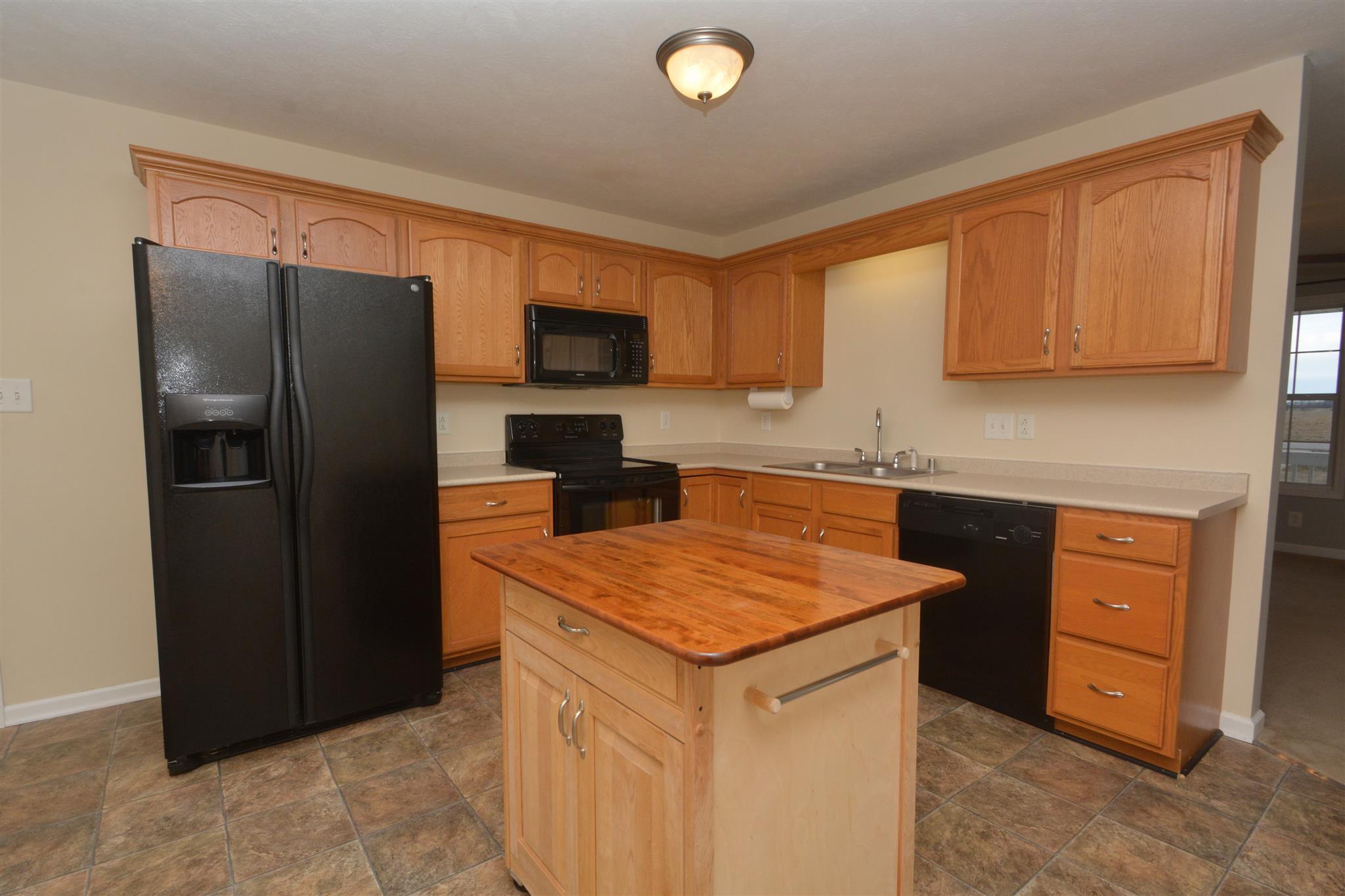 10495 Bell Station Road Oak Grove, KY 42262 - Photo 9 of 18 a kitchen with stainless steel appliances granite countertop a refrigerator sink and stove