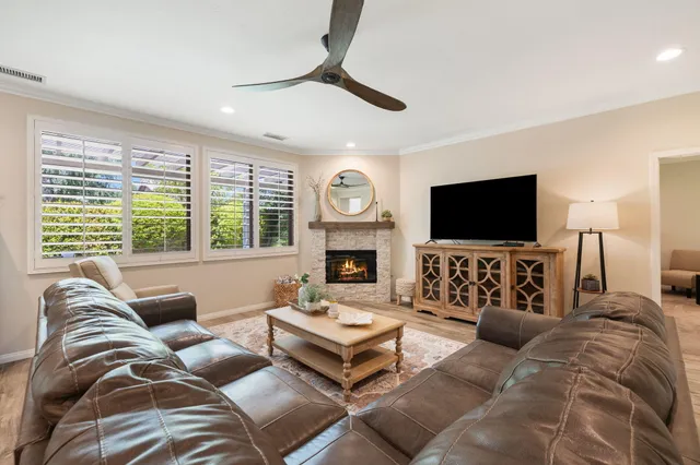 a dining room with furniture and wooden floor