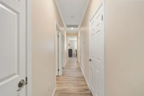 a spacious bathroom with double sink and a mirror