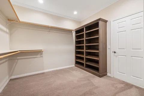 a view of a kitchen with white cabinets and sink