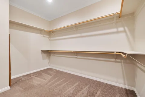 a view of a patio with table and chairs under an umbrella