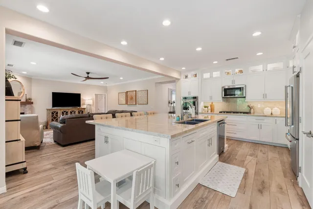 a kitchen with stainless steel appliances kitchen island granite countertop a sink and a stove