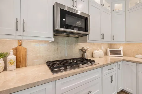 a kitchen with a cabinets and white appliances