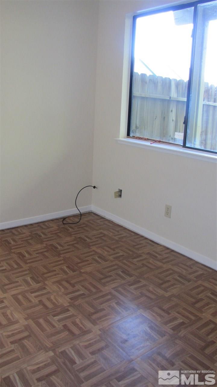 3470 Bowie Road Reno, NV 89503 - Photo 12 of 25 a view of an empty room with wooden floor and a window