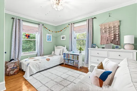 a bedroom with furniture and a large window
